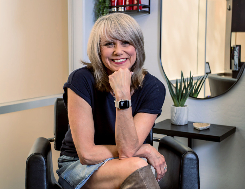 hairstylist sitting in her styling chair